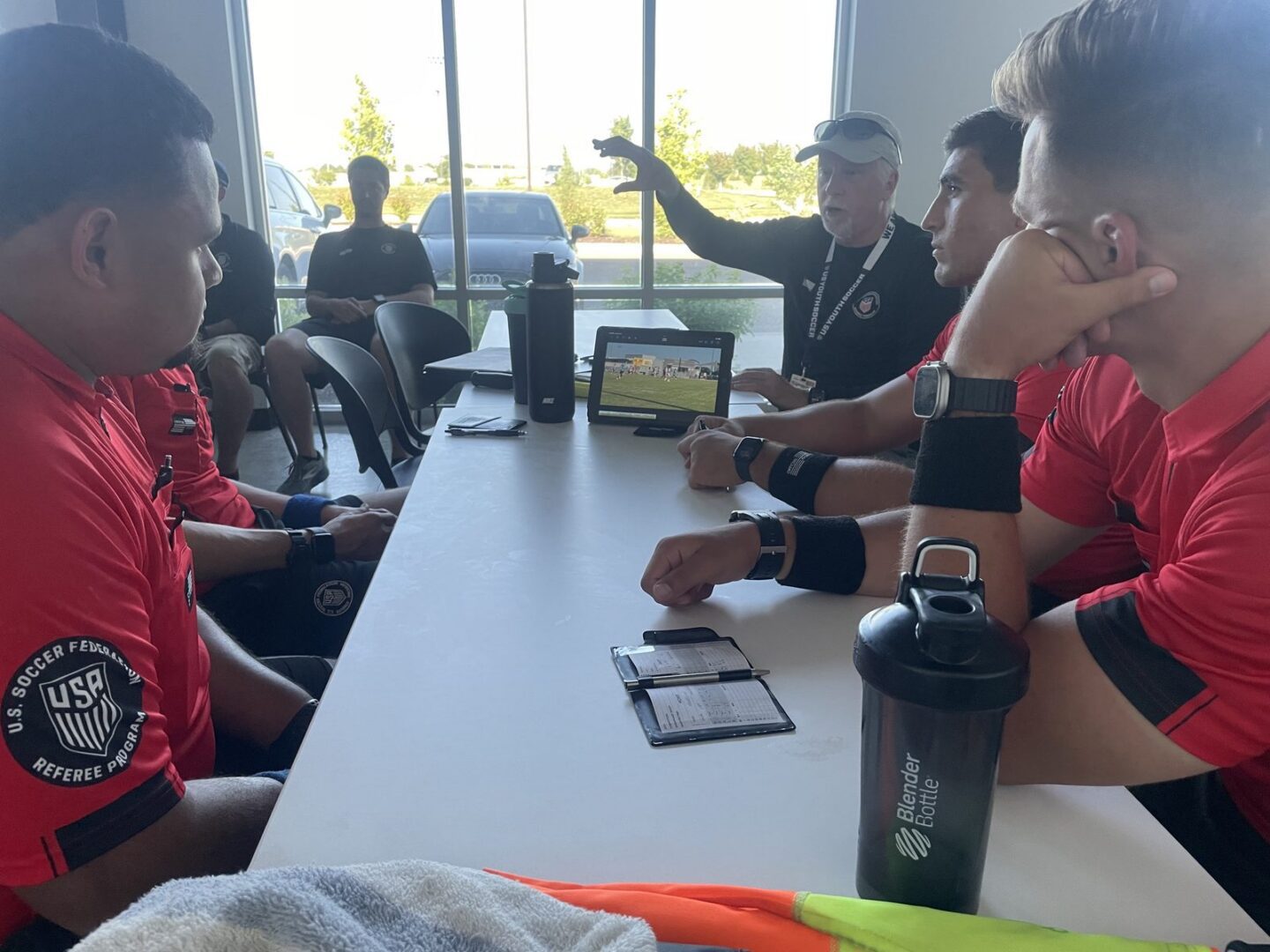 Referees receive feedback from a referee coach
